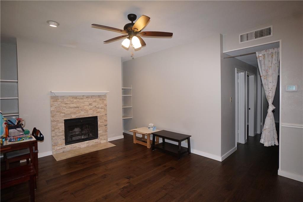203 East 31st Street, Unit 103 Austin, TX 78705 - Photo 5 of 32 a living room with furniture and a fireplace