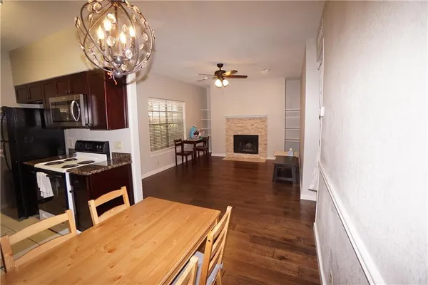 a dining room with furniture a chandelier and wooden floor