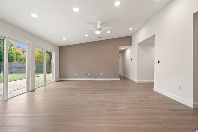 a view of an empty room with glass door and balcony