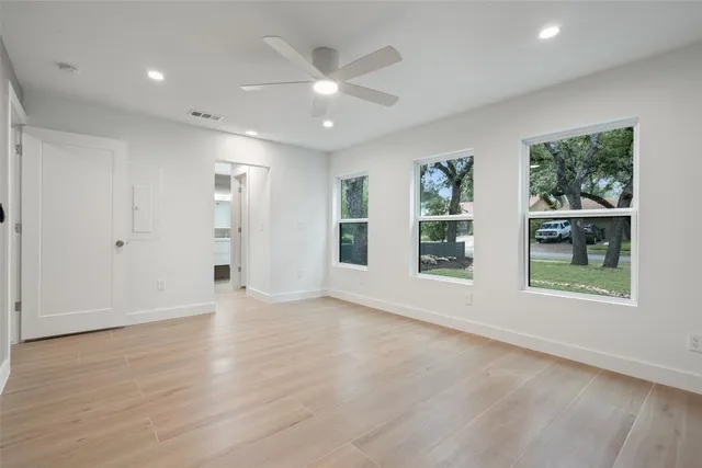 wooden floor in an empty room with a window
