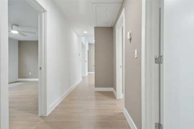 a view of a hallway with a wooden door