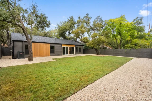 a backyard of a house with table and chairs