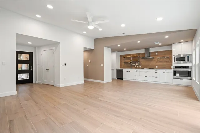 a view of a kitchen with a sink and a refrigerator
