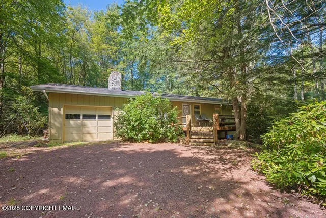 a view of a house with a patio and a yard