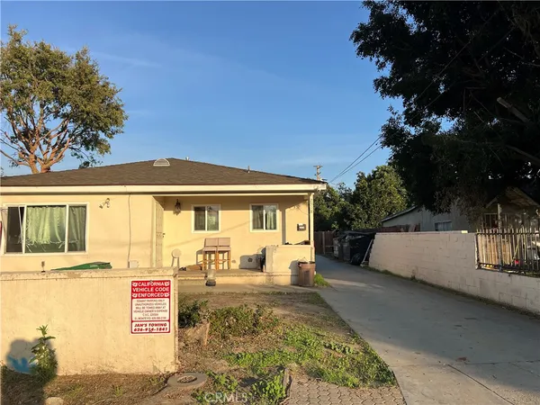 a view of a house with a backyard and a patio