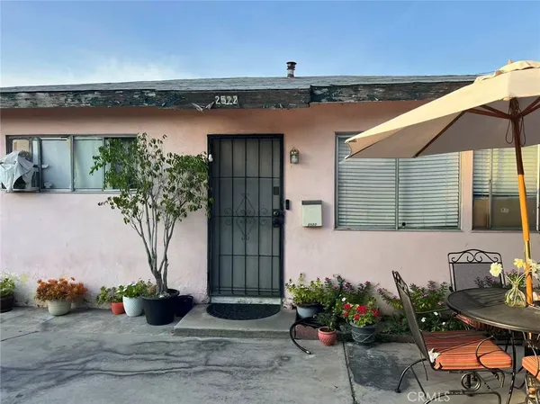 a view of a house with potted plants