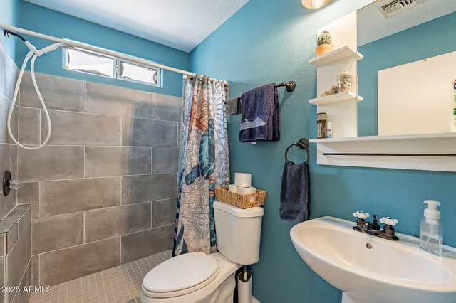 a bathroom with a bathtub and shower