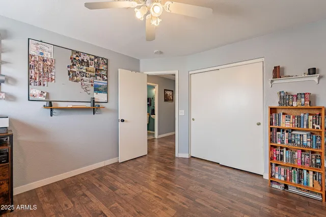 a view of a room with wooden floor and windows