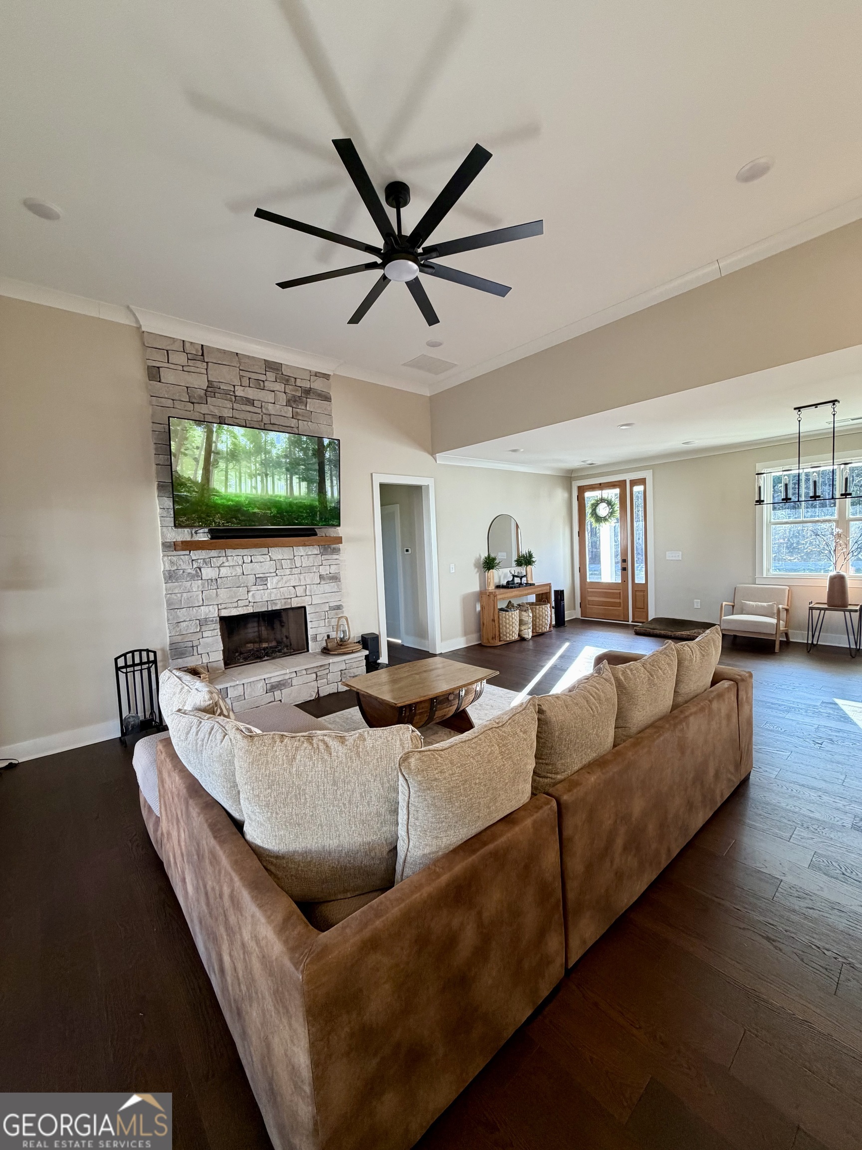 3050 Mahlon Smith Road Social Circle, GA 30025 - Photo 14 of 37 a living room with furniture a flat screen tv and a fireplace