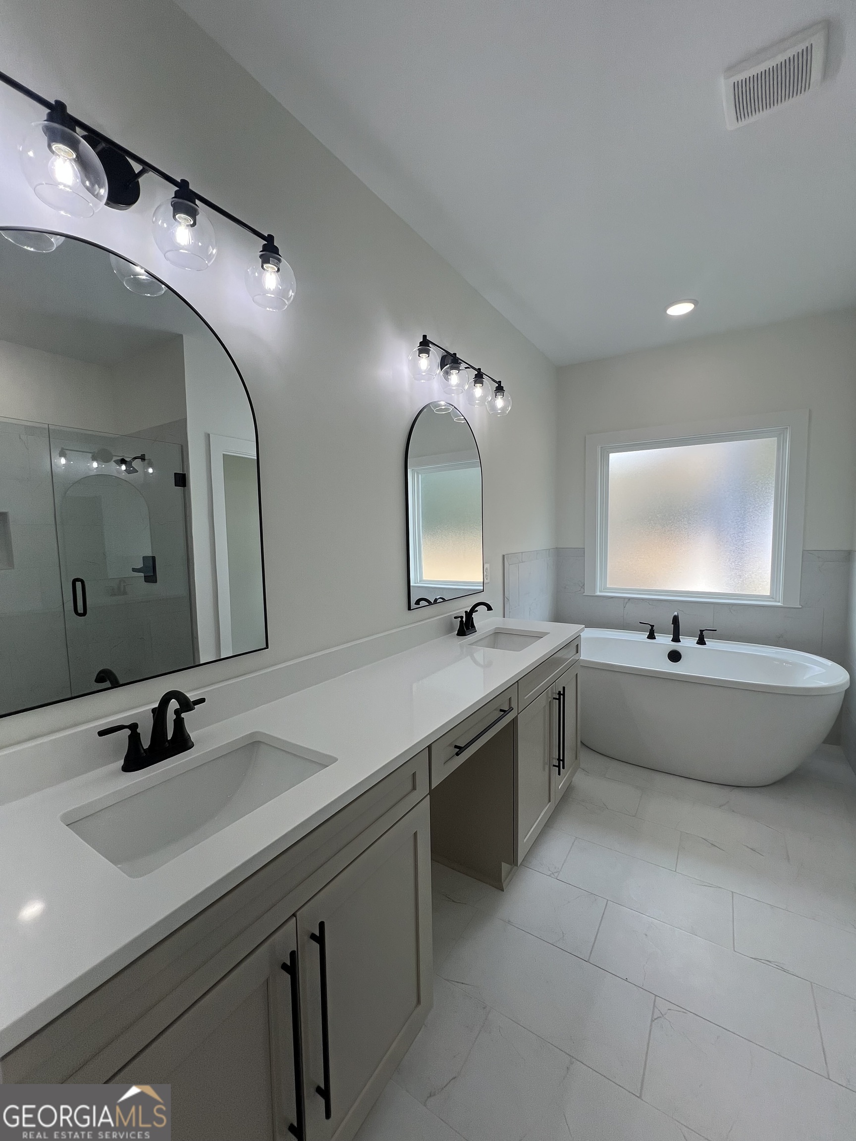 3050 Mahlon Smith Road Social Circle, GA 30025 - Photo 21 of 37 a large bathroom with a large tub sink and mirror