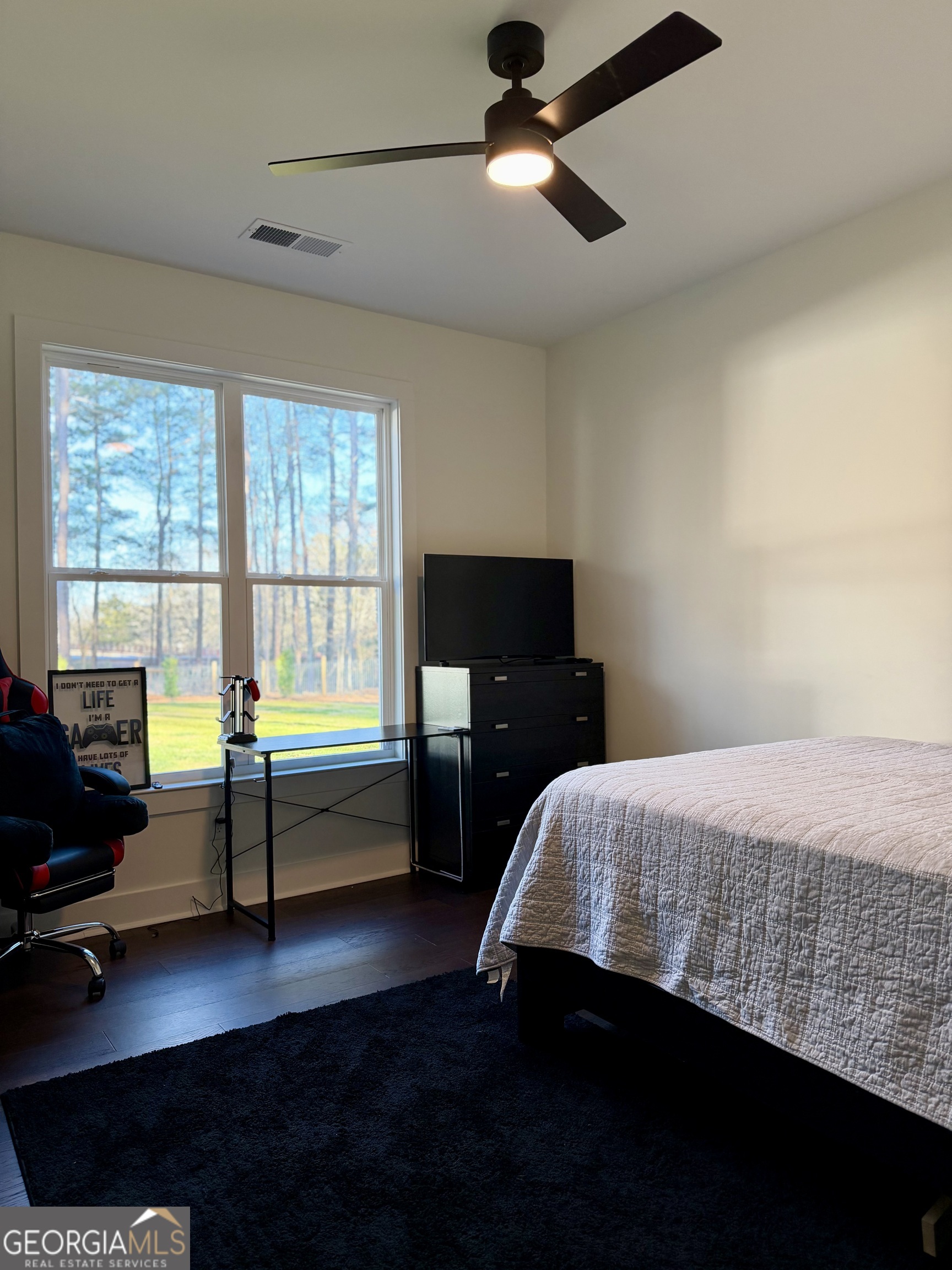 3050 Mahlon Smith Road Social Circle, GA 30025 - Photo 30 of 37 a bedroom with a bed and wooden floor