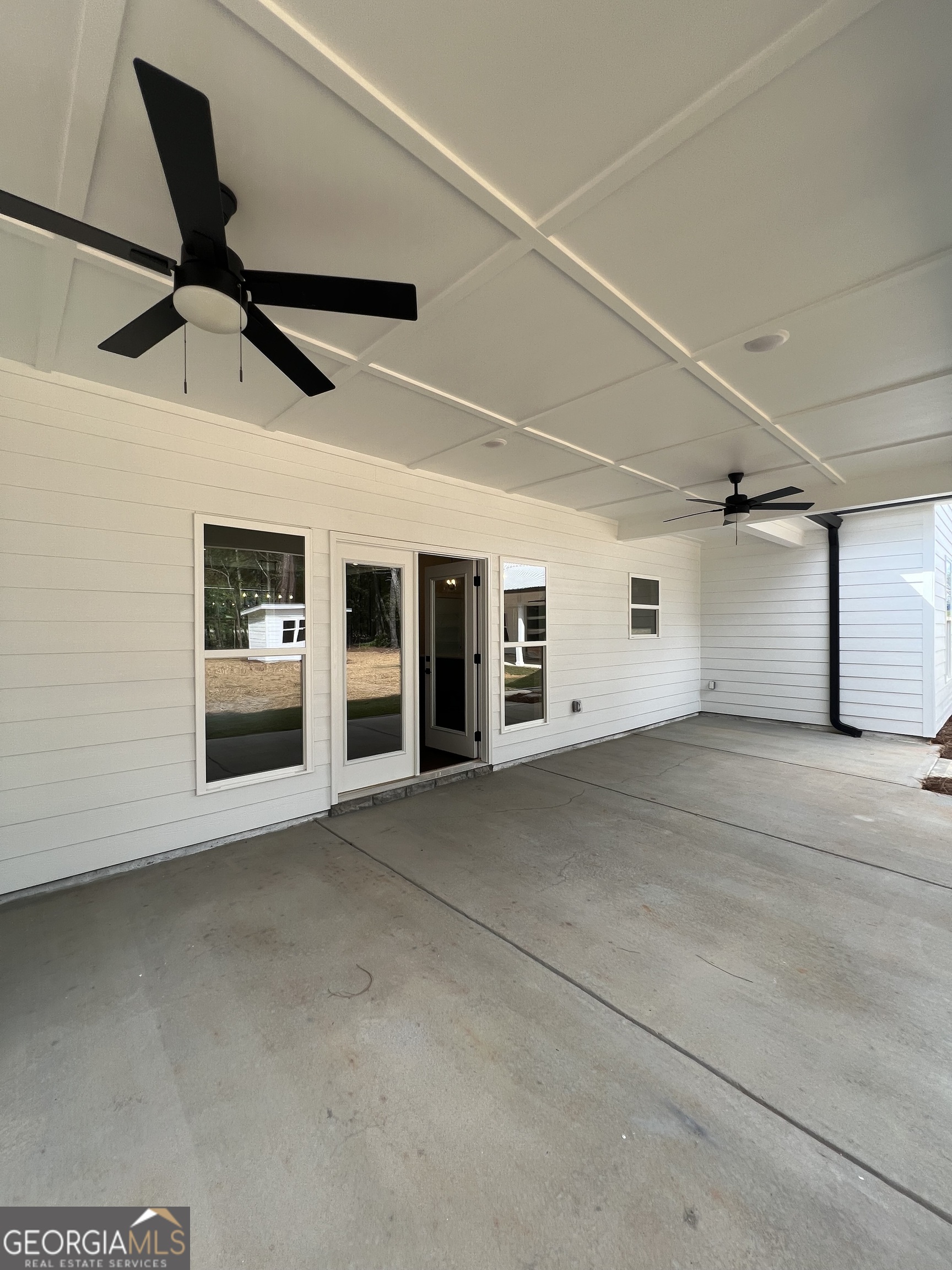 3050 Mahlon Smith Road Social Circle, GA 30025 - Photo 32 of 37 a view of a building with a garage