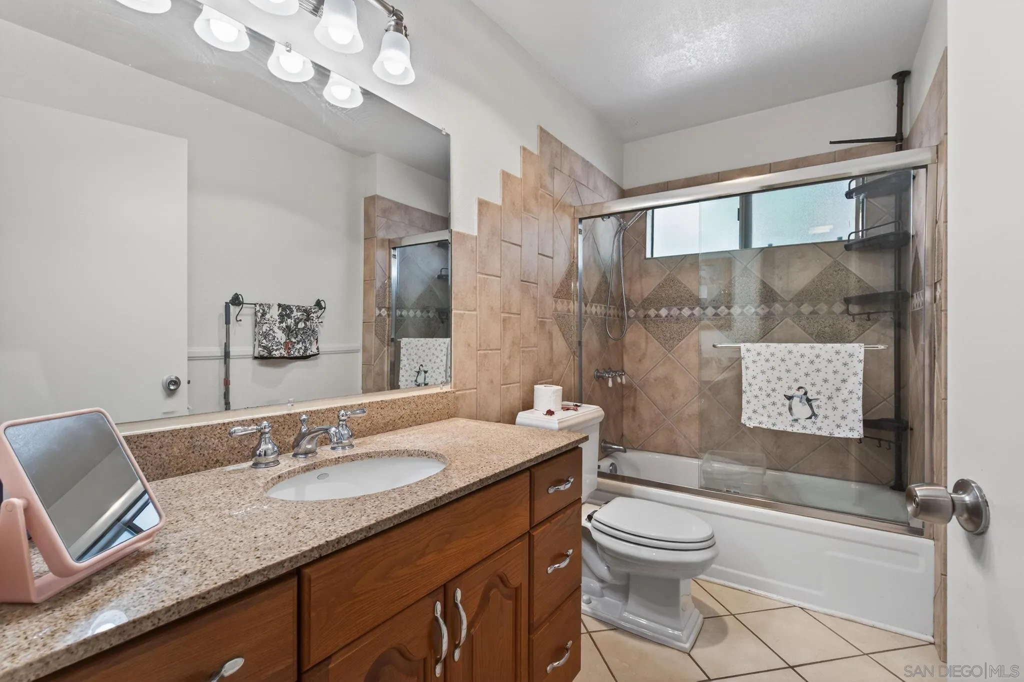 2157 Arnold Way, Unit 201 Alpine, CA 91901 - Photo 11 of 21 a bathroom with a granite countertop sink toilet a mirror a vanity and shower