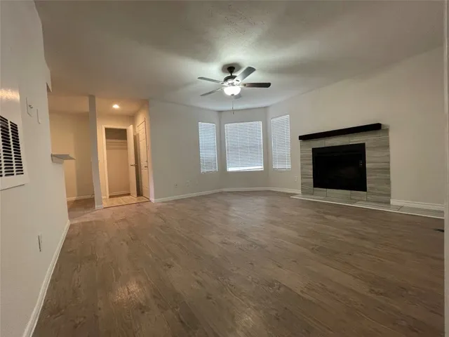 en empty room with windows and a fireplace