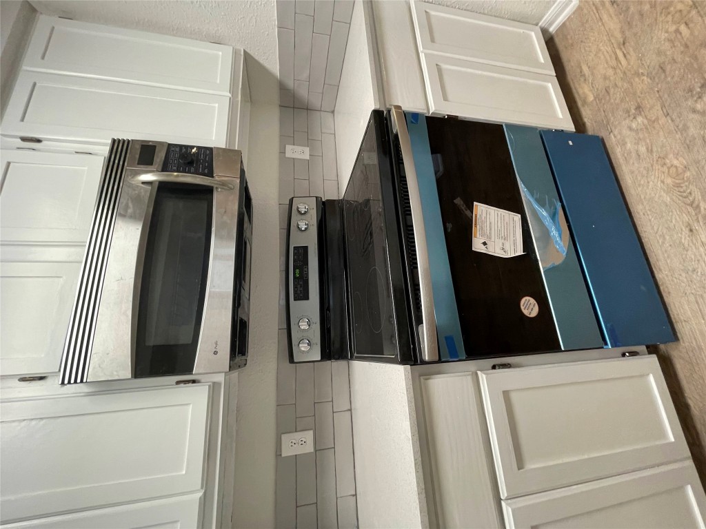 8806 Schick Road, Unit A Austin, TX 78729 - Photo 10 of 13 a stove top oven sitting inside of a kitchen
