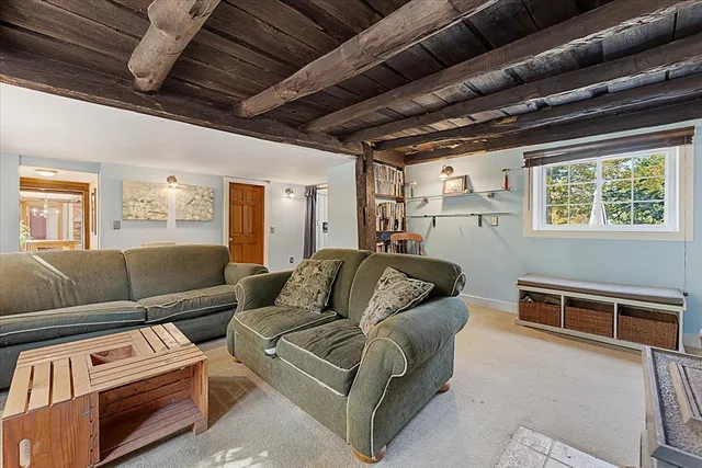 a living room with furniture a ceiling fan and a window