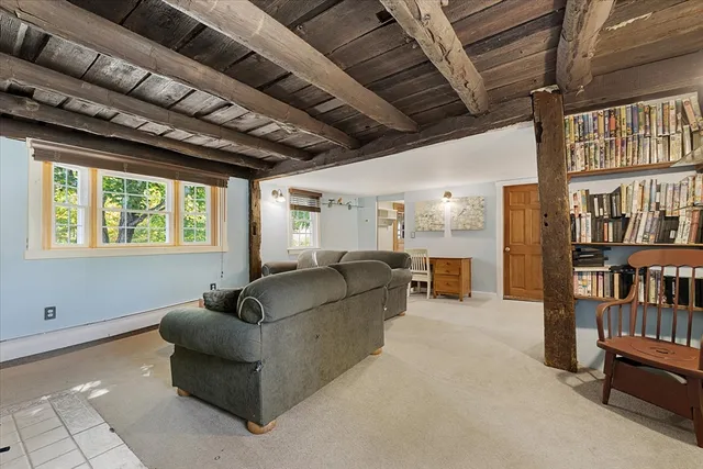 a living room with furniture and a book shelf