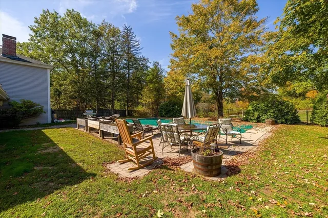 a view of swimming pool with outdoor seating and plants