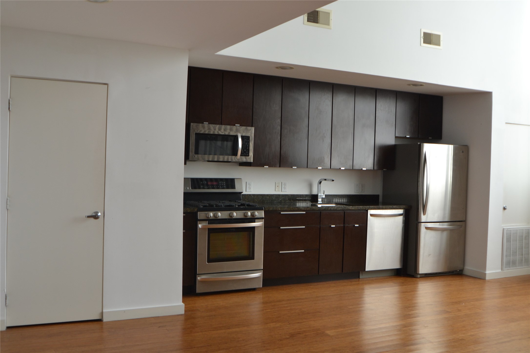 1316 Cleveland Street, Unit C Houston, TX 77019 - Photo 25 of 38 a kitchen with a sink a refrigerator and a stove top oven
