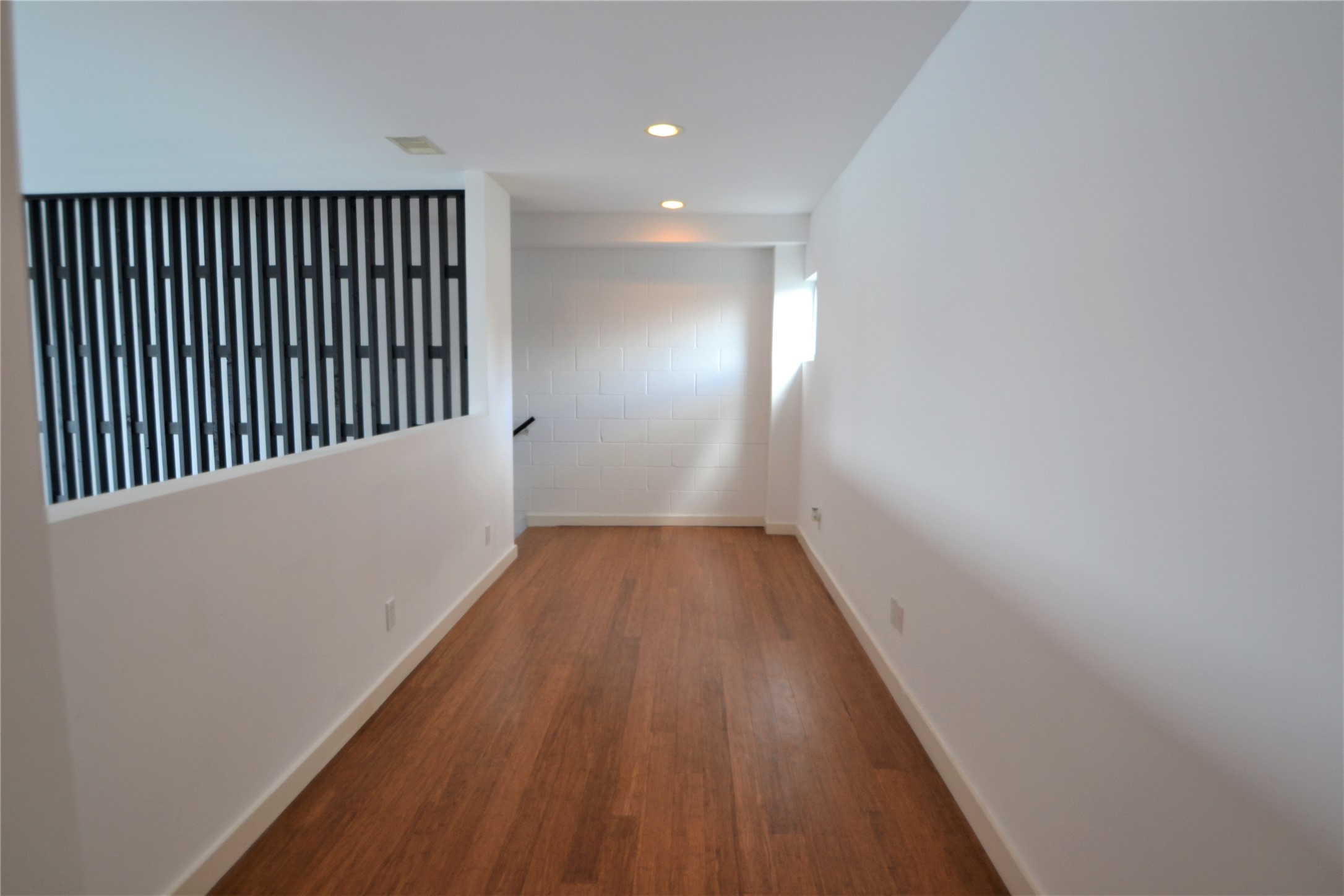 1316 Cleveland Street, Unit C Houston, TX 77019 - Photo 30 of 38 a view of a hallway with wooden floor