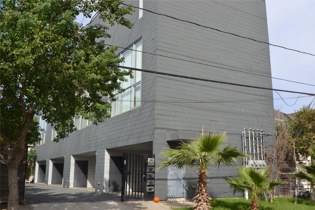 a front view of a house with plants