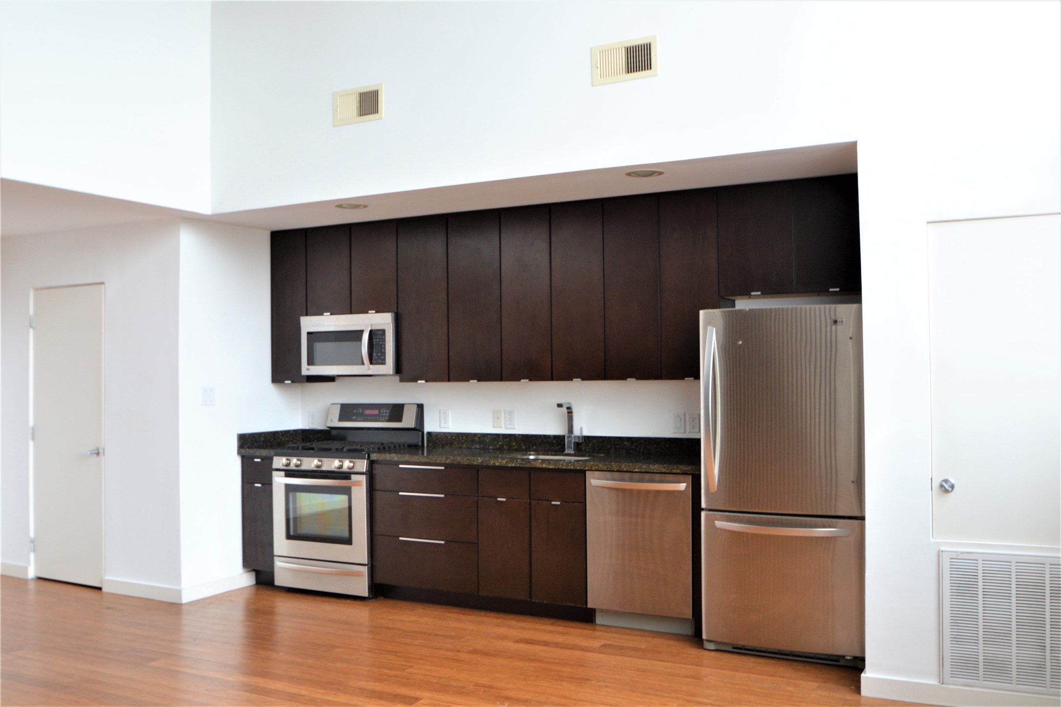 1316 Cleveland Street, Unit C Houston, TX 77019 - Photo 5 of 38 a kitchen with a sink a refrigerator and cabinets