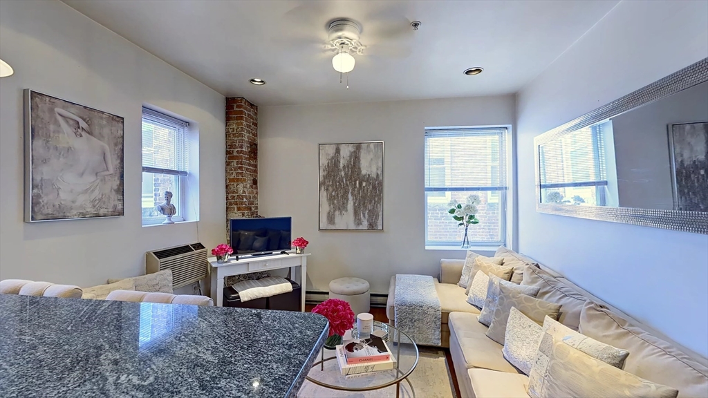 91 Prince Street, Unit 18 Boston, MA 02113 - Photo 3 of 13 a living room with furniture window and a flat screen tv