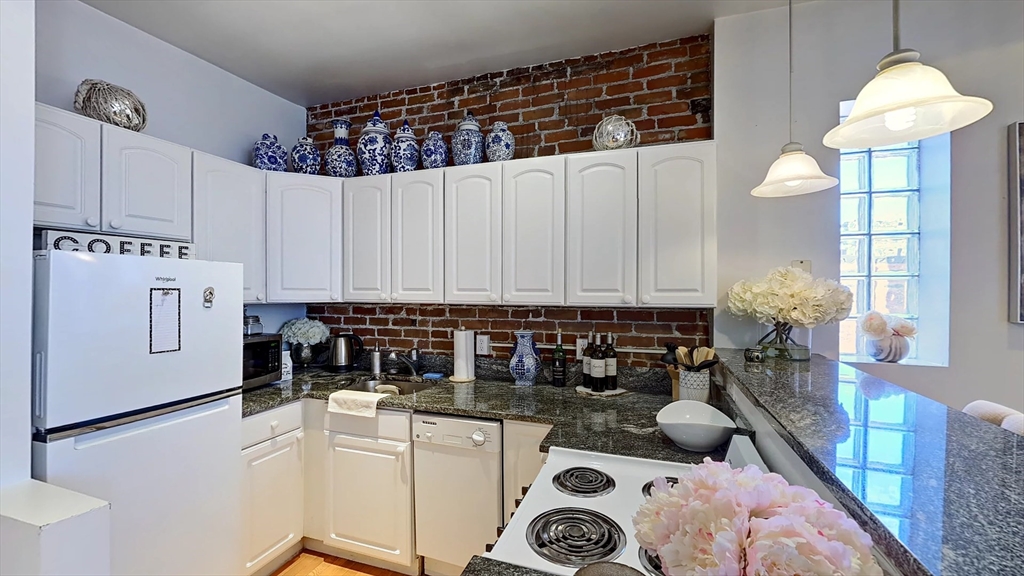 91 Prince Street, Unit 18 Boston, MA 02113 - Photo 4 of 13 a kitchen with a white cabinets and window