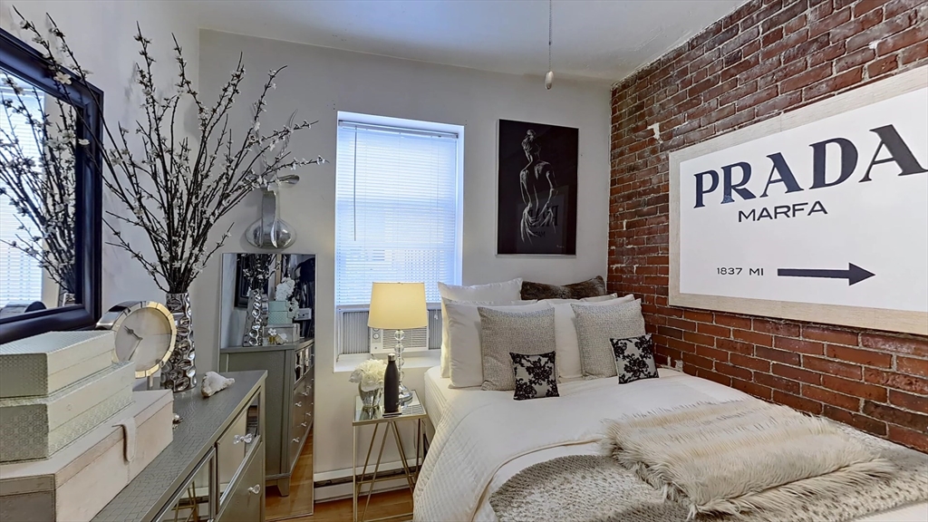 91 Prince Street, Unit 18 Boston, MA 02113 - Photo 5 of 13 a bedroom with a bed and a couch