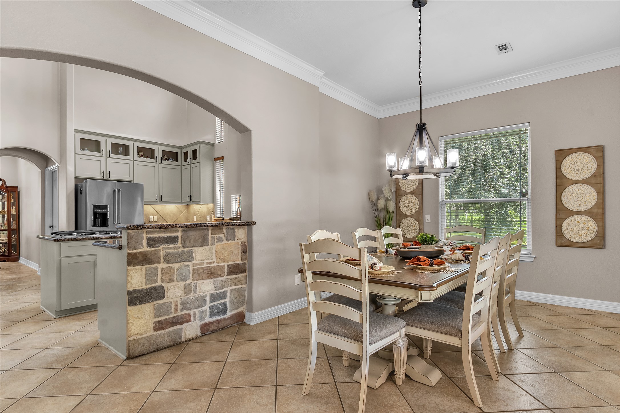 4910 Brookside Road Pearland, TX 77581 - Photo 19 of 20 a dining room with furniture a chandelier and kitchen view