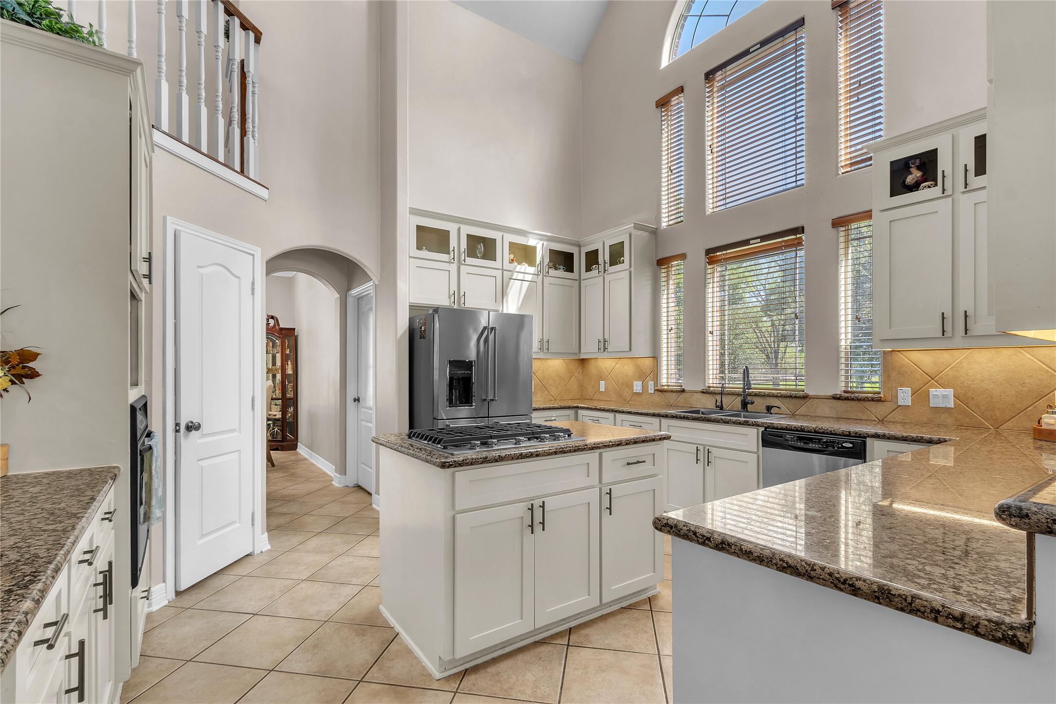 4910 Brookside Road Pearland, TX 77581 - Photo 4 of 20 a kitchen with stainless steel appliances granite countertop a sink and a stove