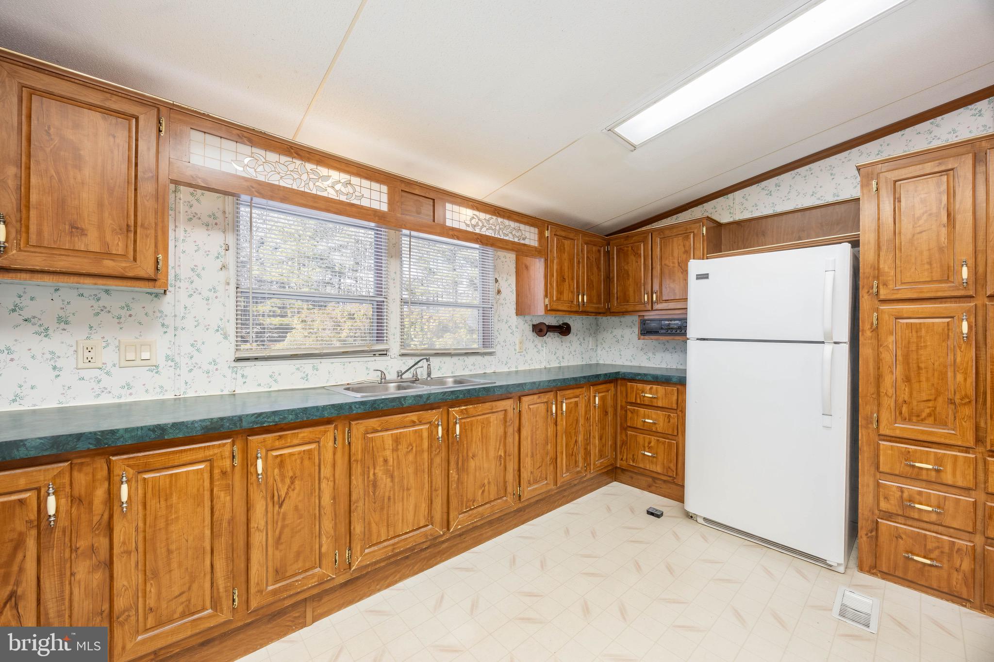 22147 Royal Oak Road Quantico, MD 21856 - Photo 15 of 65 a kitchen with stainless steel appliances granite countertop a refrigerator a sink and a cabinets