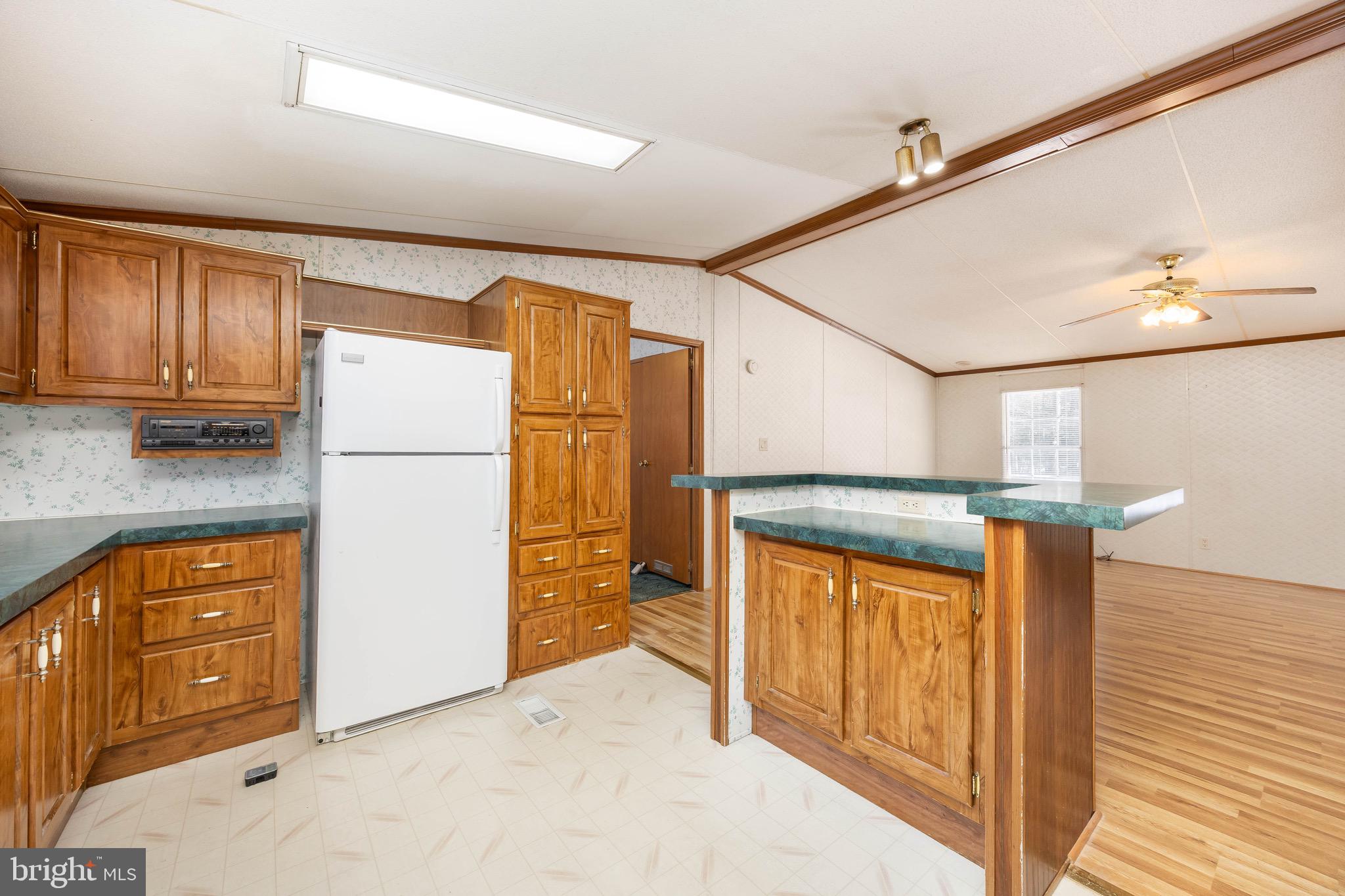 22147 Royal Oak Road Quantico, MD 21856 - Photo 16 of 65 a kitchen with stainless steel appliances granite countertop a refrigerator and a stove top oven