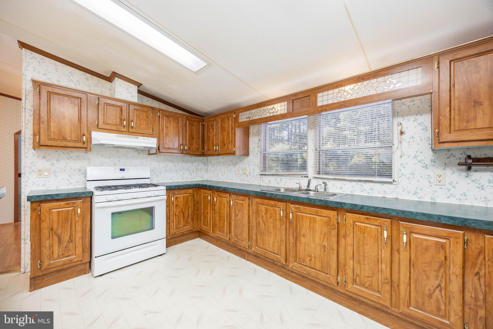 22147 Royal Oak Road Quantico, MD 21856 - Photo 17 of 65 a kitchen with stainless steel appliances granite countertop a stove sink and cabinets