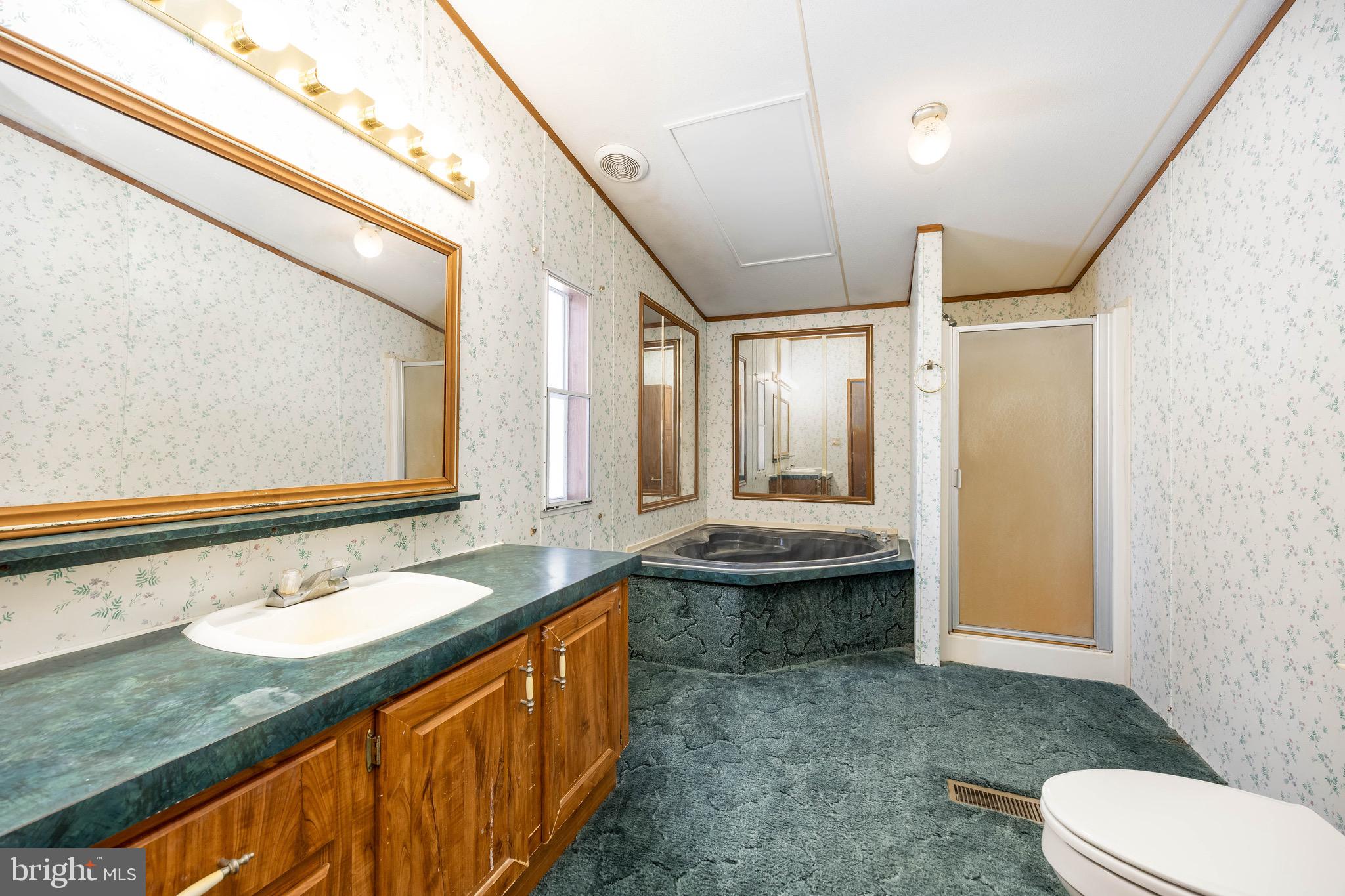 22147 Royal Oak Road Quantico, MD 21856 - Photo 29 of 65 a bathroom with a granite countertop sink mirror vanity and toilet