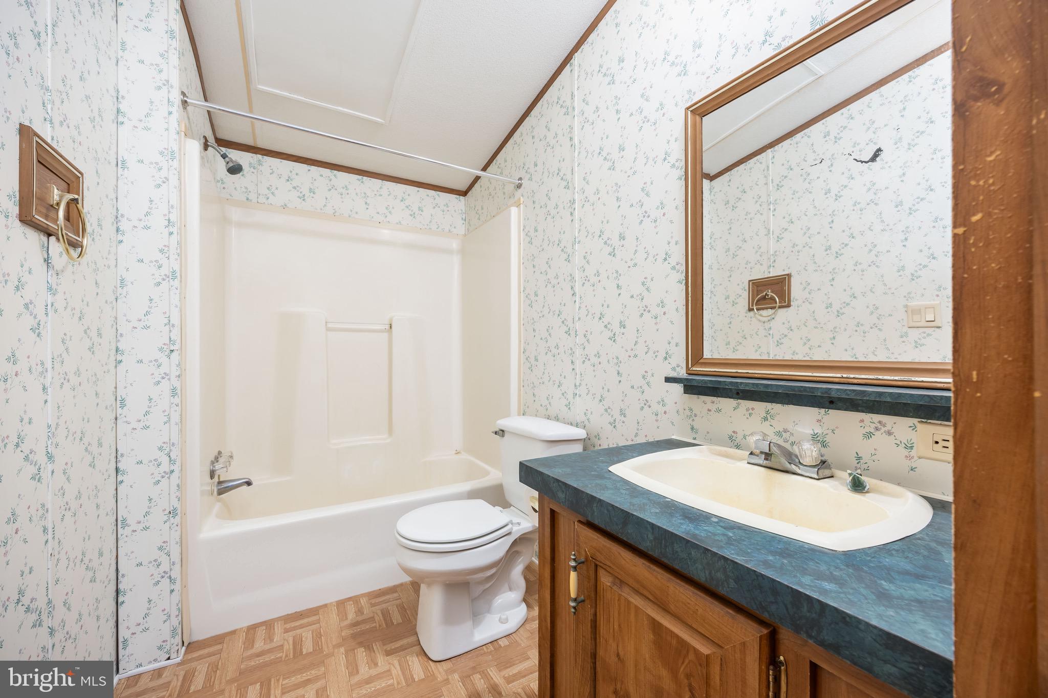 22147 Royal Oak Road Quantico, MD 21856 - Photo 41 of 65 a bathroom with a granite countertop sink toilet and shower
