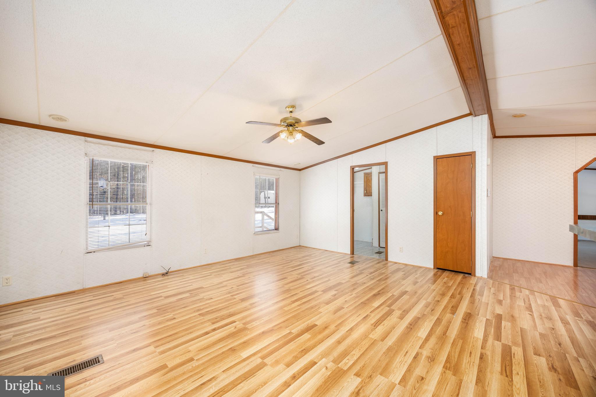 22147 Royal Oak Road Quantico, MD 21856 - Photo 9 of 65 a view of empty room with wooden floor and fan