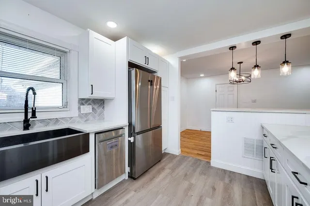 a view of empty room with wooden floor and window