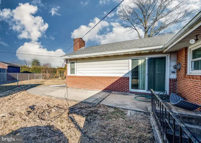 a view of a house with a yard covered in snow