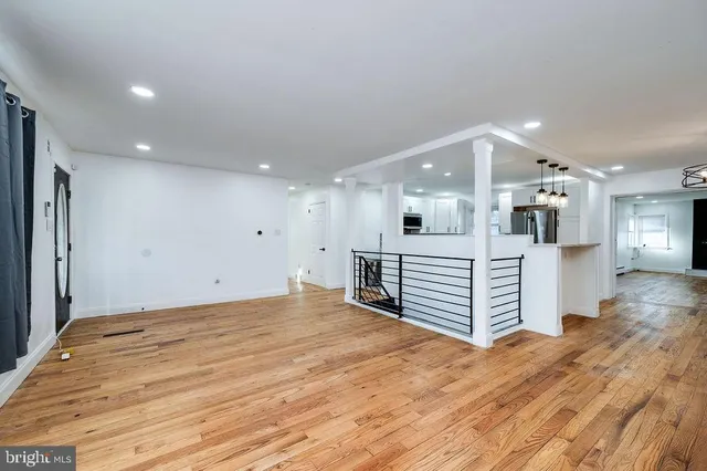 a view of empty room with a fireplace and wooden floor