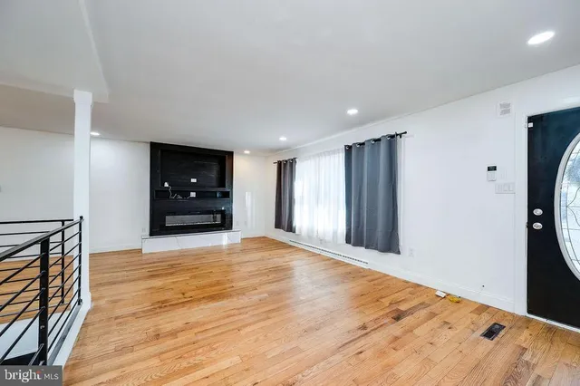 a view of a room with wooden floor chandelier and entryway