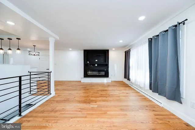 a large kitchen with granite countertop a large counter top appliances and cabinets