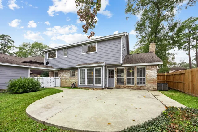 a view of an empty room with wooden floor and windows