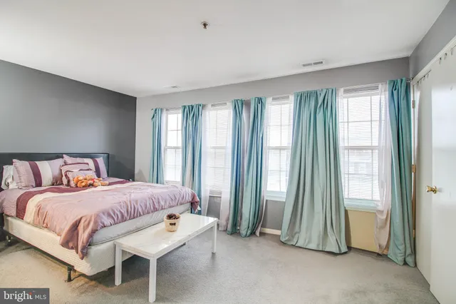 a bedroom with a bed and a mirror