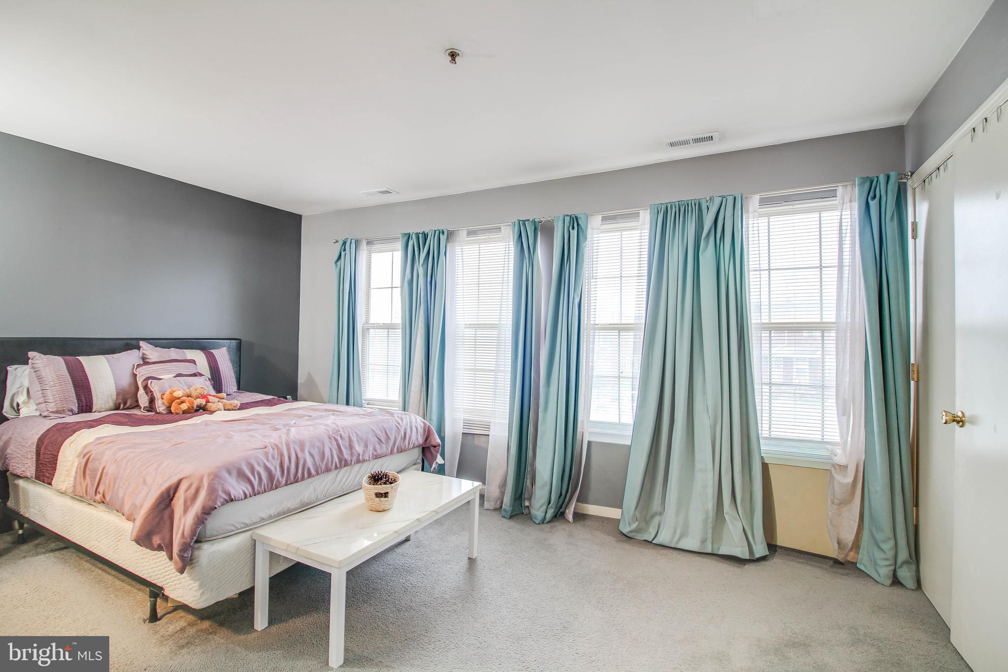 1408 Olmstead Street Curtis Bay, MD 21226 - Photo 12 of 40 a bedroom with a bed and a mirror