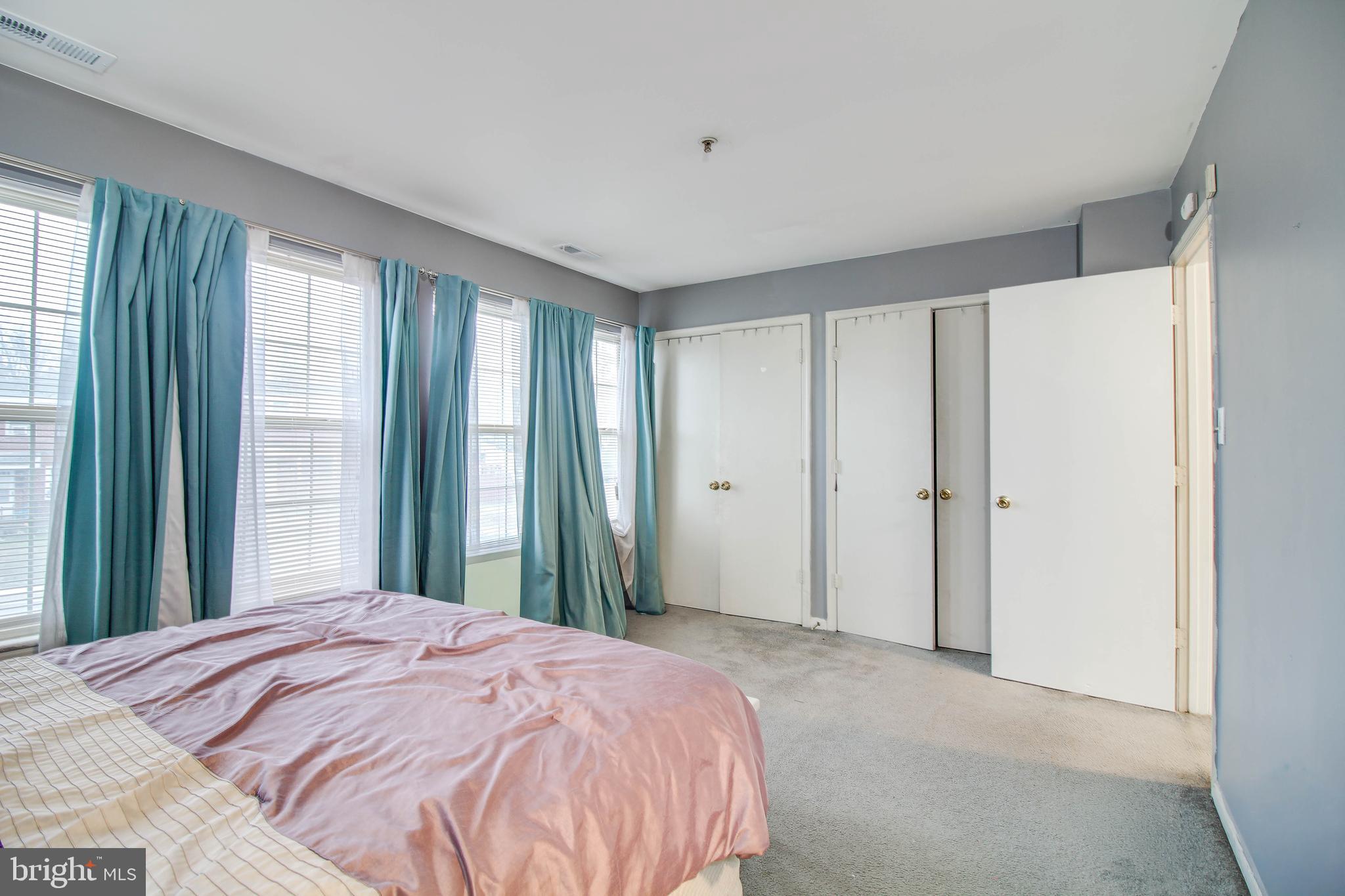 1408 Olmstead Street Curtis Bay, MD 21226 - Photo 13 of 40 a bed sitting in a bedroom next to a window and a bathroom