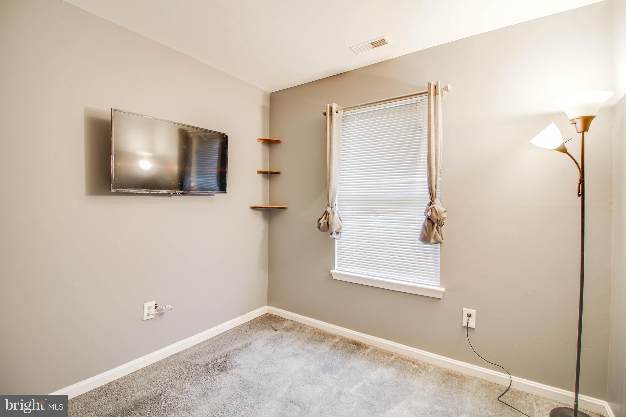 1408 Olmstead Street Curtis Bay, MD 21226 - Photo 19 of 40 a view of a livingroom with a ceiling fan and window