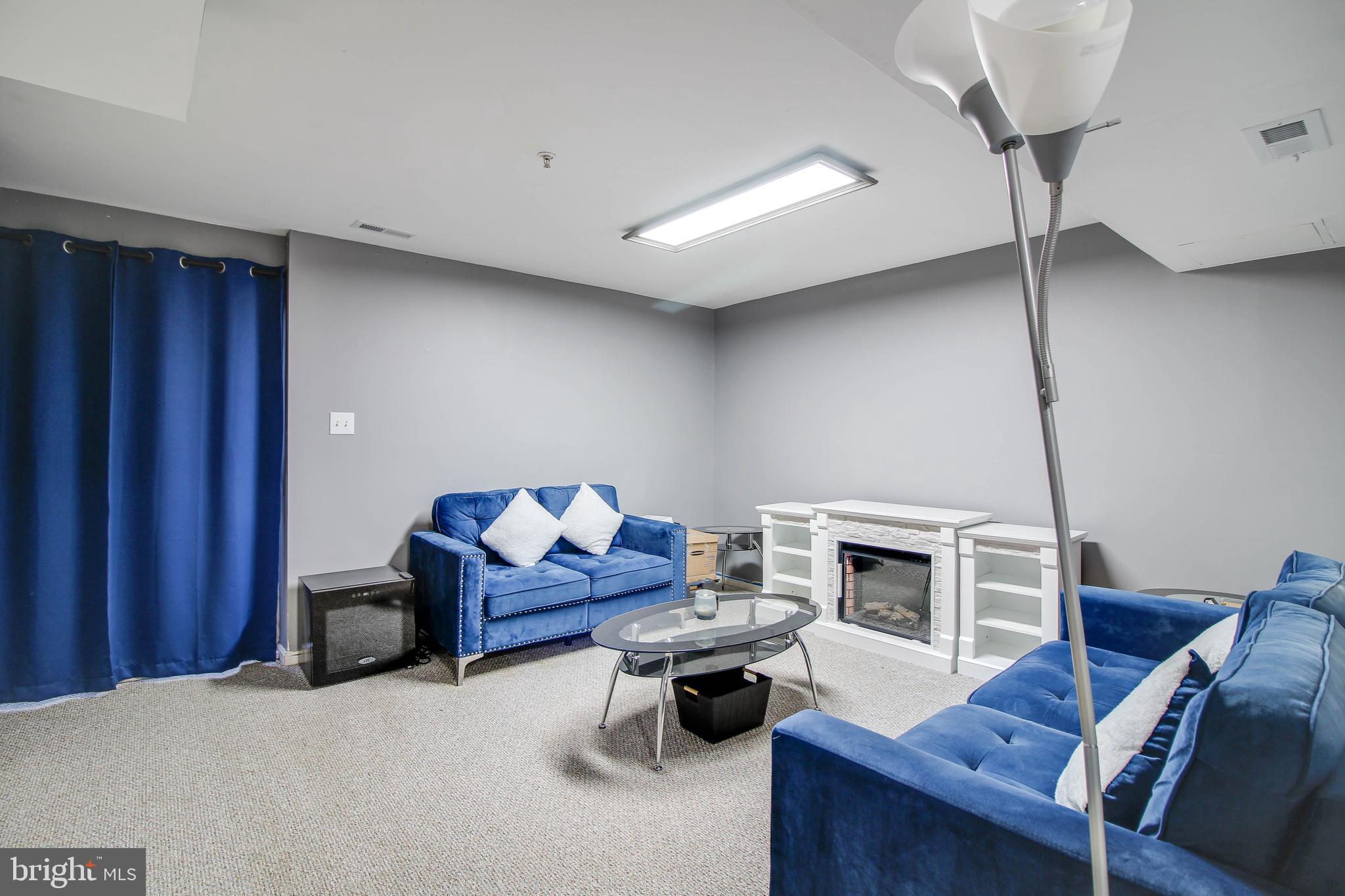 1408 Olmstead Street Curtis Bay, MD 21226 - Photo 21 of 40 a living room with furniture and a fireplace