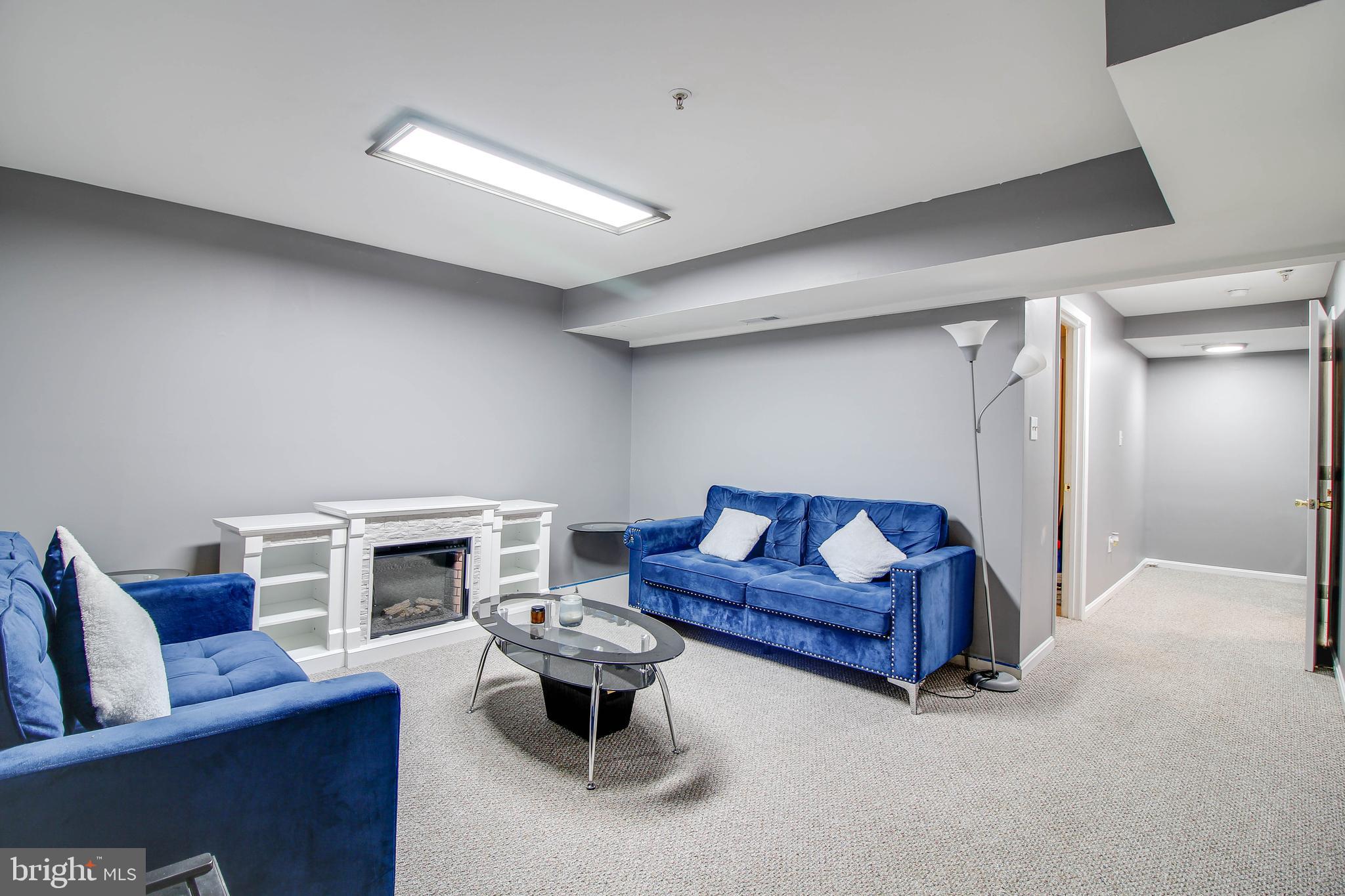1408 Olmstead Street Curtis Bay, MD 21226 - Photo 22 of 40 a living room with furniture and a fireplace