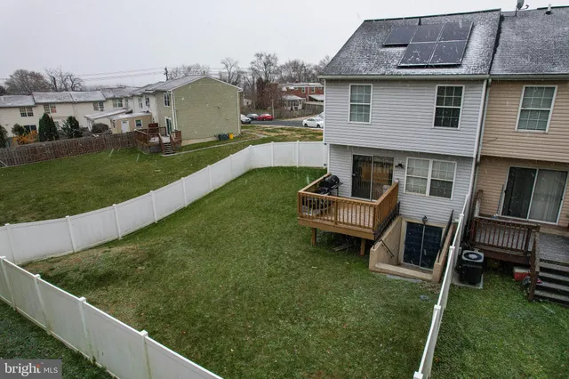 a view of a house with a yard and sitting area